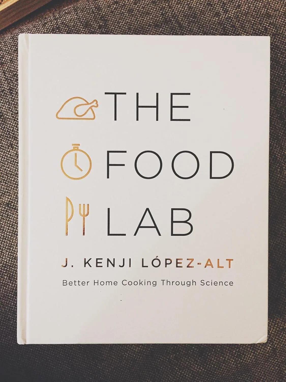 Customer photo of The Food Lab cookbook open to a page about cheese emulsification and queso science