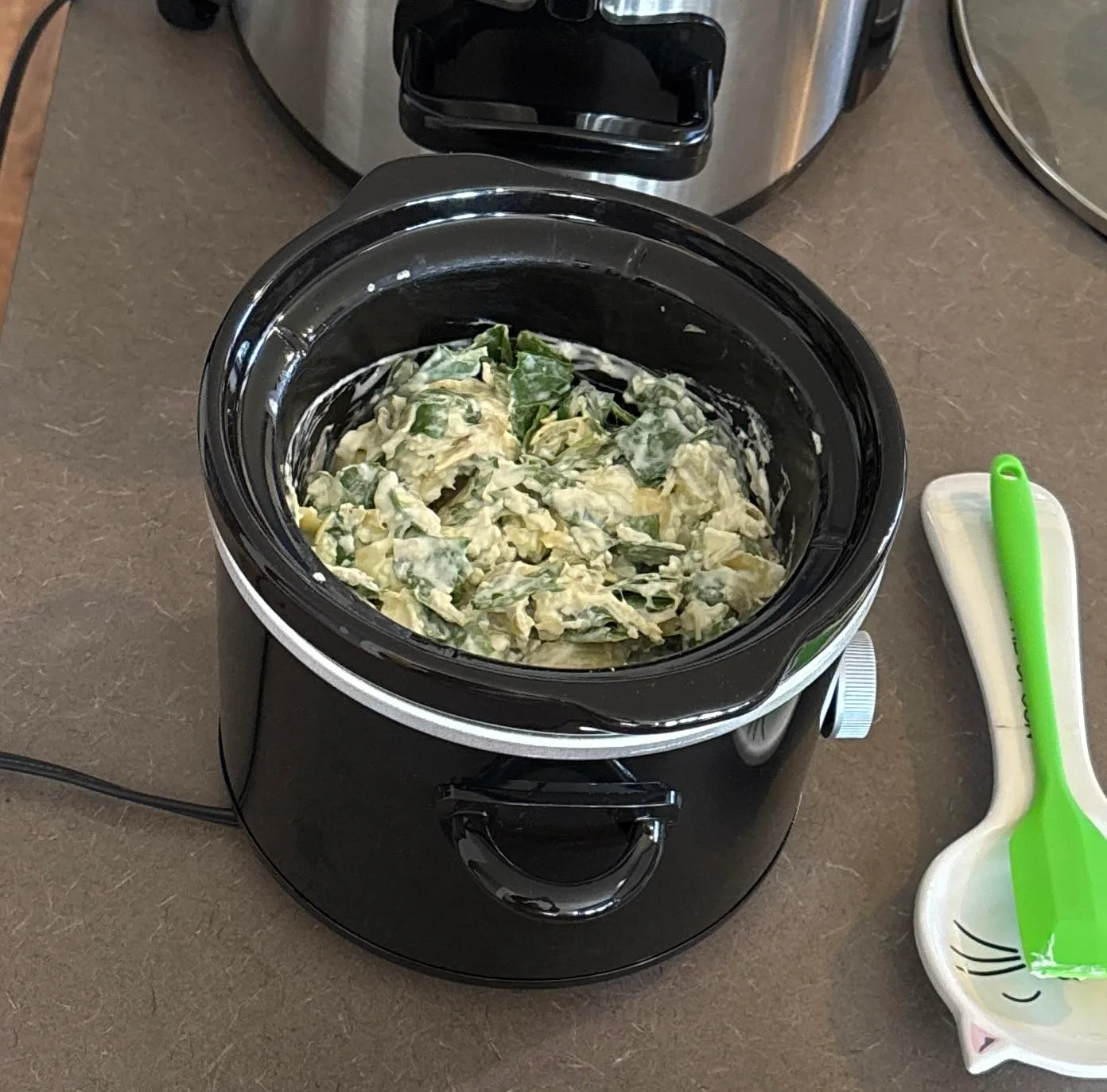 Customer photo of slow cooker with melted cheese dip being scooped with tortilla chips
