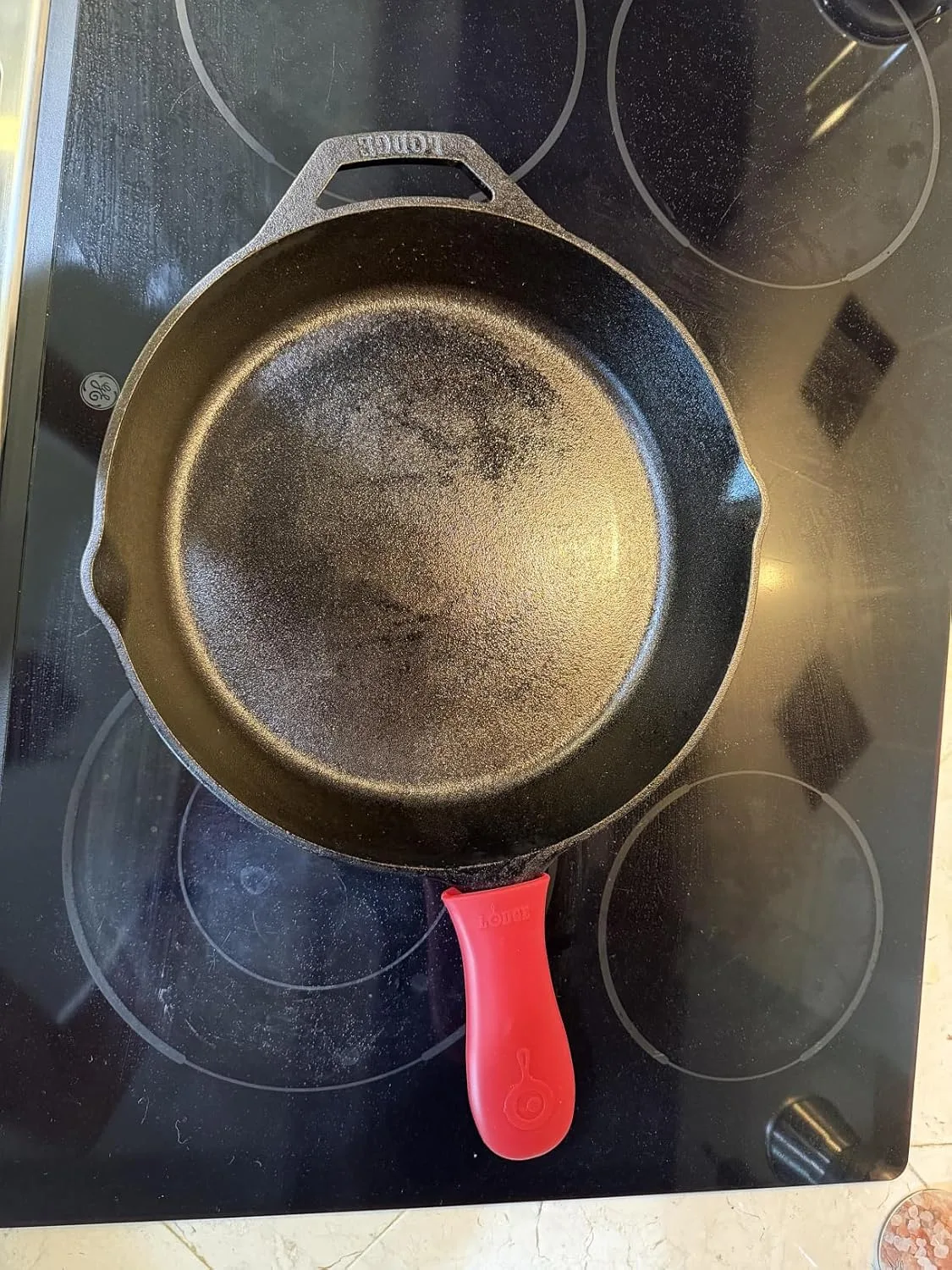 Customer photo of cast iron skillet with melted cheese dip bubbling on stovetop