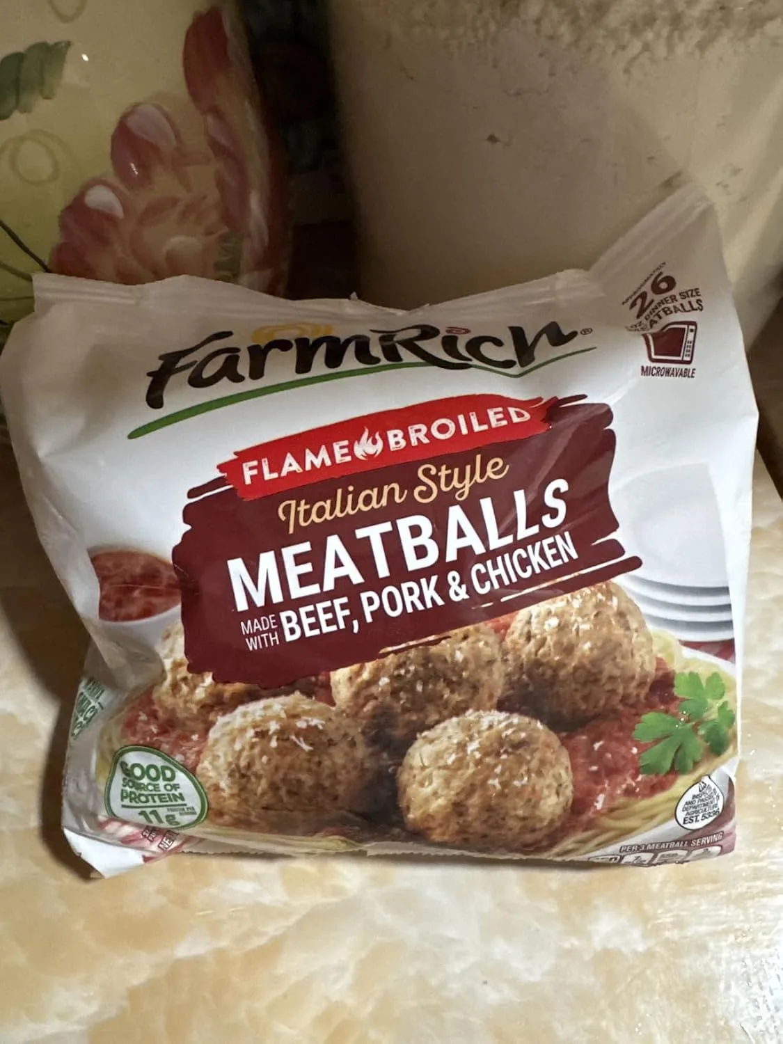Customer photo of cheesy meatball dip in a serving dish with melted cheese and meatballs