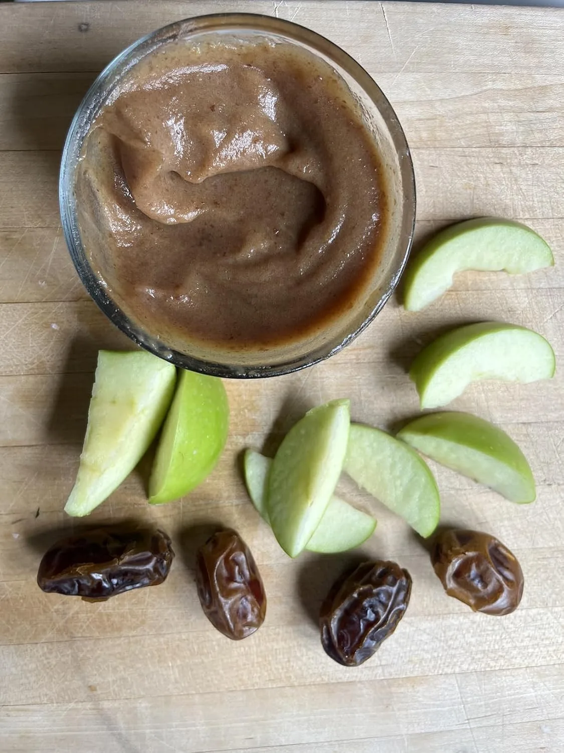 Customer photo of whipped goat cheese dip served with bacon pieces and dates