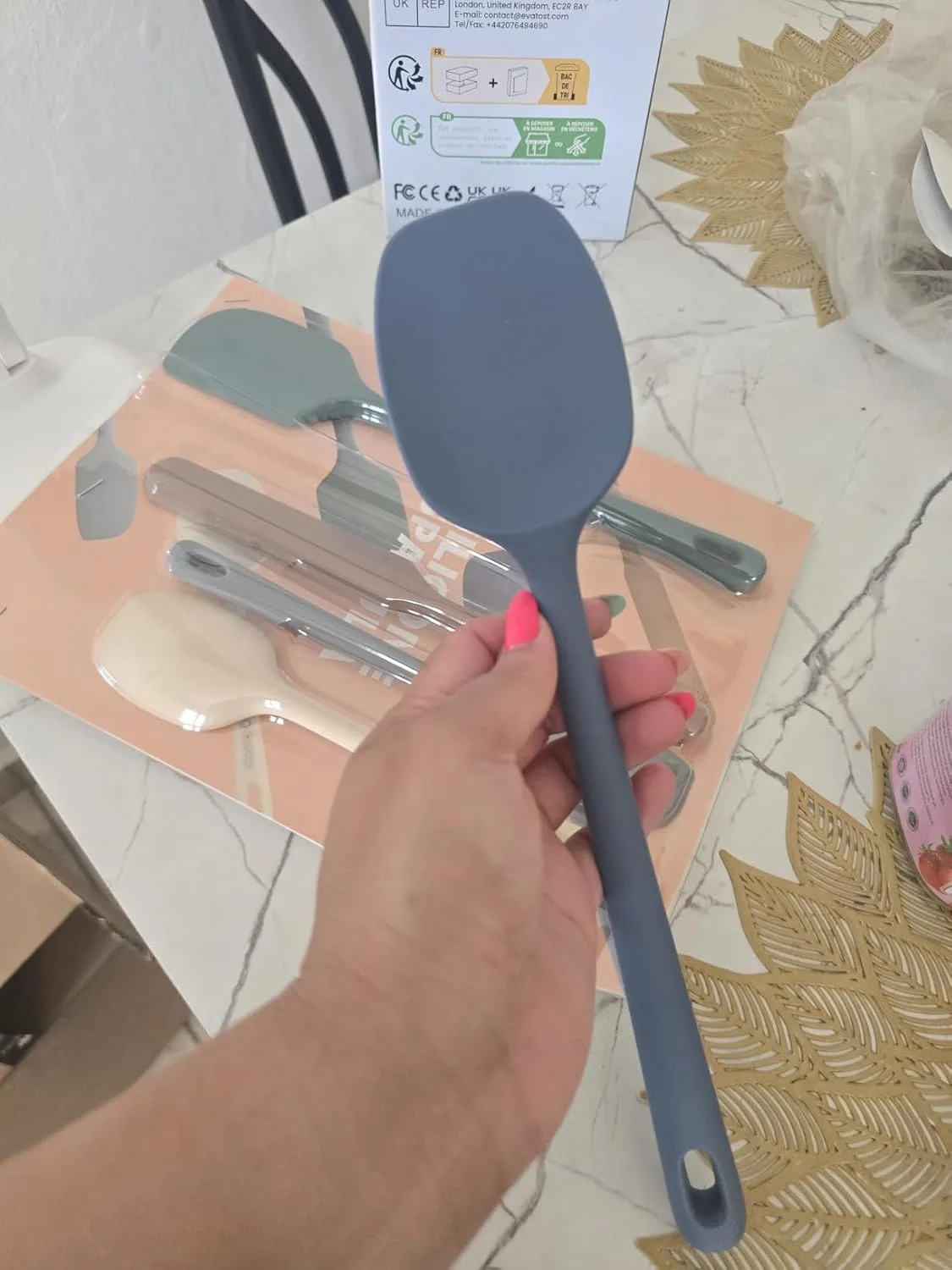 Customer photo of silicone spatulas in various colors laid out on a kitchen counter