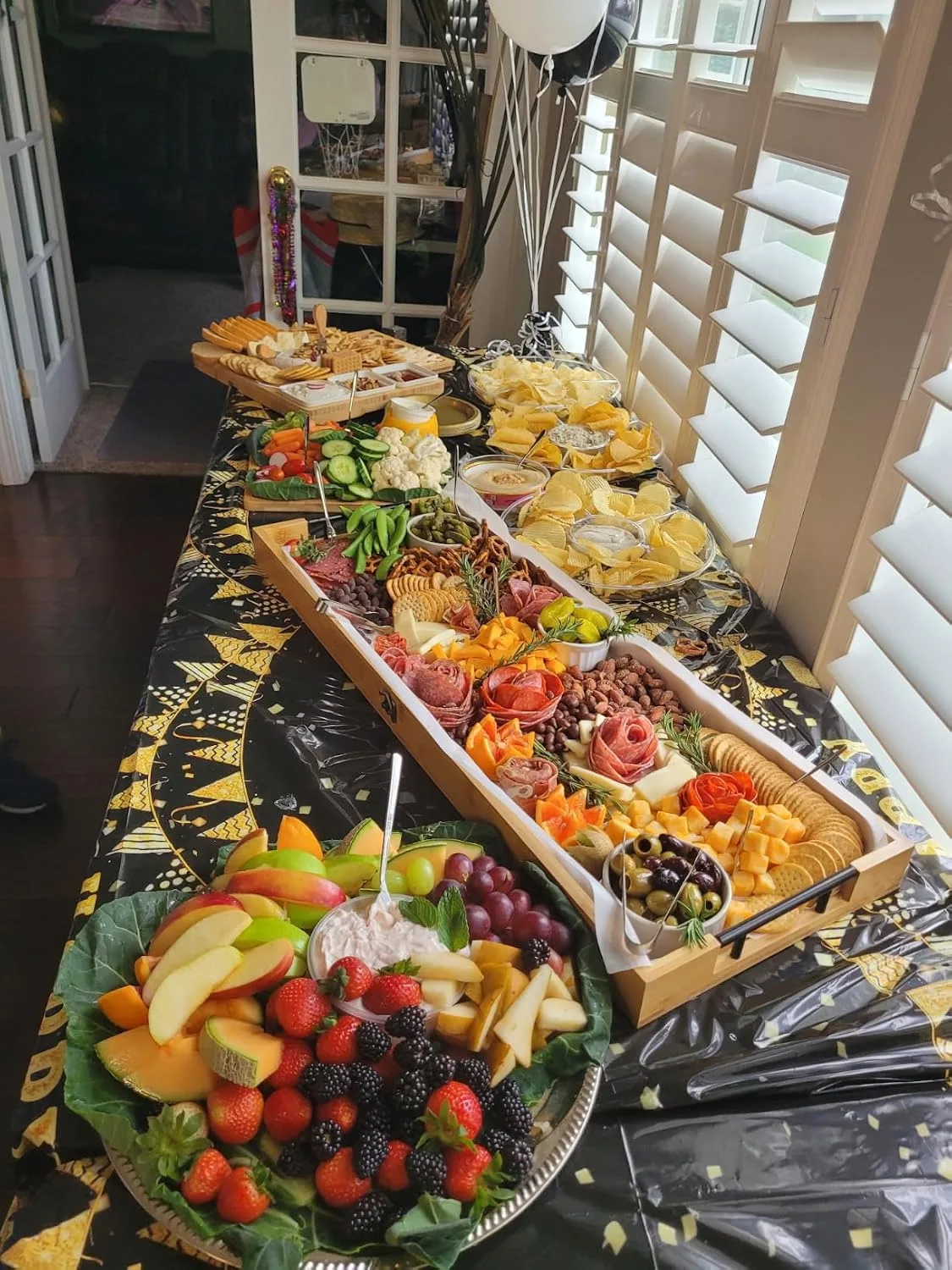 Customer photo of bamboo serving board with various dips and spreads arranged on surface